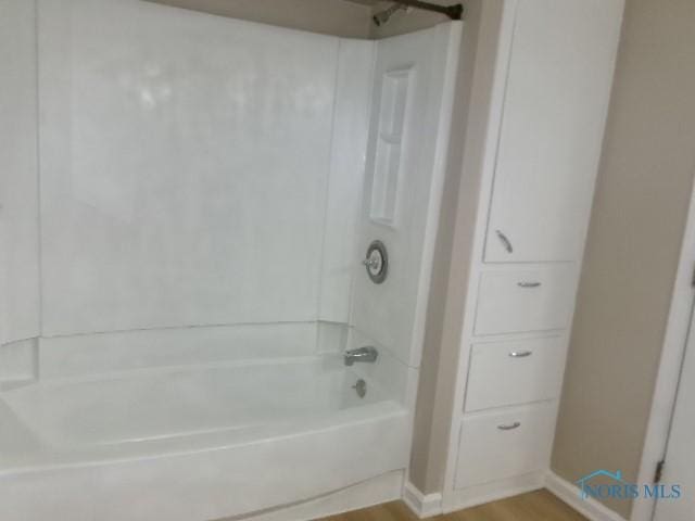 530 N Taft Ave, Ottawa, OH 45875 - bathroom with bathtub / shower combination and wood finished floors