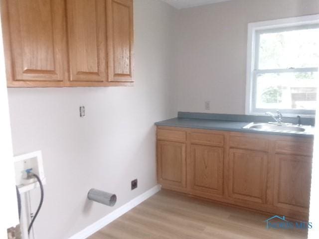 530 N Taft Ave, Ottawa, OH 45875 - laundry room featuring cabinet space, hookup for a washing machine, and light wood-type flooring