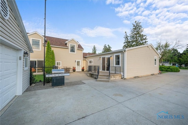 855 Strotz Dr, Toledo, OH 43612 - rear view of house with a garage and a patio area