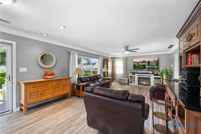 855 Strotz Dr, Toledo, OH 43612 - living room featuring healthy amount of natural light, ceiling fan, light wood finished floors, a glass covered fireplace, and recessed lighting