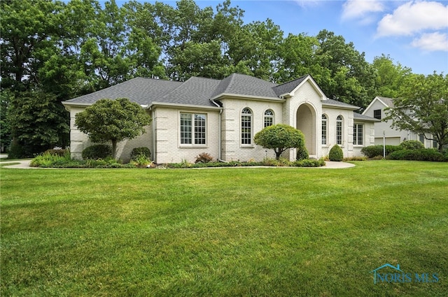 8076 Trent Lock Dr, Waterville, OH 43566 - view of front of house with a front lawn, roof with shingles, and brick siding