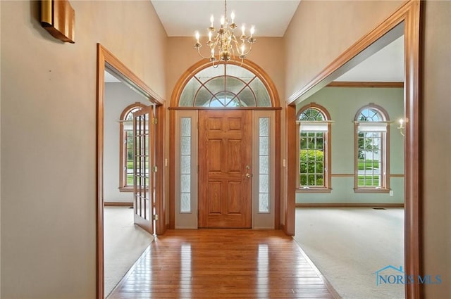 8076 Trent Lock Dr, Waterville, OH 43566 - entryway with a chandelier, hardwood / wood-style floors, and a high ceiling