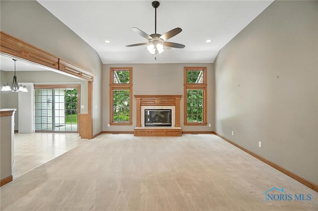 8076 Trent Lock Dr, Waterville, OH 43566 - unfurnished living room featuring a glass covered fireplace, a ceiling fan, light carpet, a chandelier, and recessed lighting