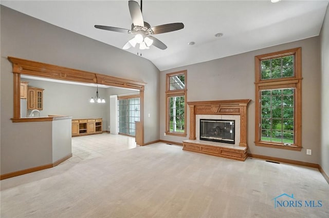 8076 Trent Lock Dr, Waterville, OH 43566 - unfurnished living room featuring vaulted ceiling, a high end fireplace, light carpet, a ceiling fan, and a chandelier