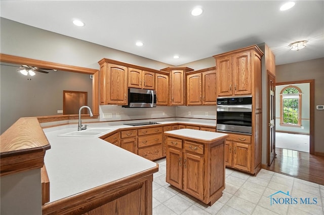 8076 Trent Lock Dr, Waterville, OH 43566 - kitchen featuring appliances with stainless steel finishes, a peninsula, light countertops, a kitchen island, and recessed lighting
