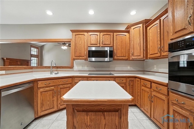 8076 Trent Lock Dr, Waterville, OH 43566 - kitchen with stainless steel appliances, light tile patterned flooring, light countertops, ceiling fan, and brown cabinets