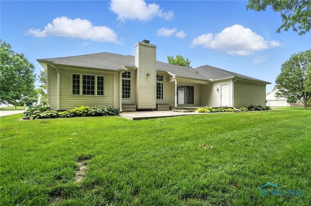 8076 Trent Lock Dr, Waterville, OH 43566 - back of property with a chimney, a lawn, and a patio