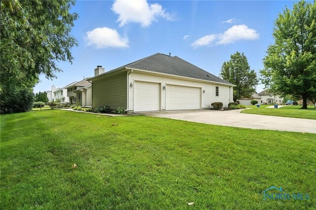 8076 Trent Lock Dr, Waterville, OH 43566 - view of side of home featuring driveway, a yard, a chimney, and an attached garage