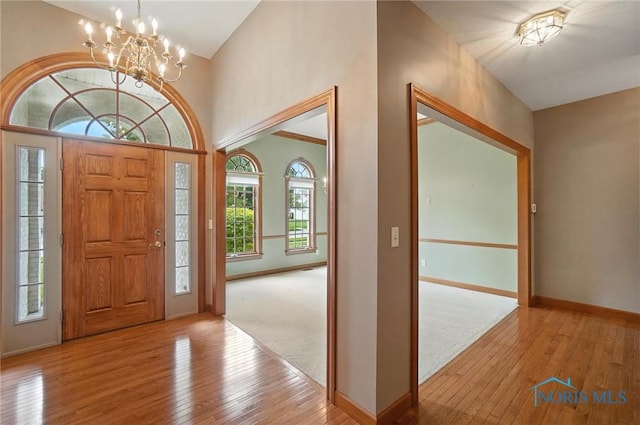 8076 Trent Lock Dr, Waterville, OH 43566 - entrance foyer with hardwood / wood-style floors, a chandelier, and lofted ceiling