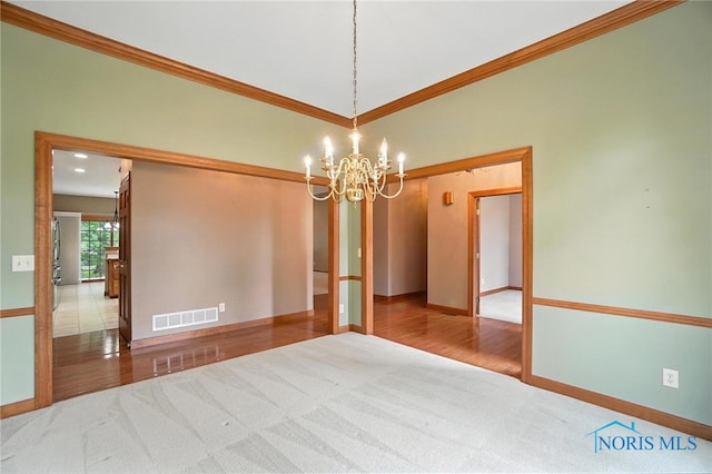 8076 Trent Lock Dr, Waterville, OH 43566 - carpeted spare room with a chandelier, ornamental molding, and wood finished floors