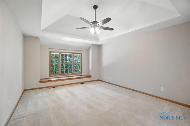 8076 Trent Lock Dr, Waterville, OH 43566 - spare room with a raised ceiling, ceiling fan, and carpet flooring
