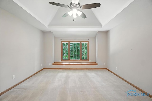 8076 Trent Lock Dr, Waterville, OH 43566 - spare room featuring a tray ceiling, ceiling fan, and light carpet