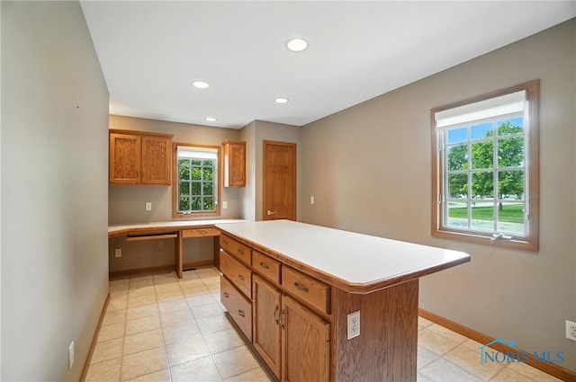 8076 Trent Lock Dr, Waterville, OH 43566 - kitchen with a center island, light countertops, built in study area, recessed lighting, and brown cabinetry