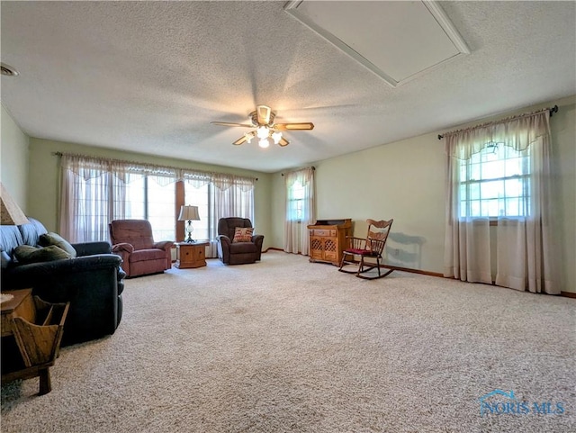209 Hawthorn Dr, Archbold, OH 43502 - living area featuring a textured ceiling, healthy amount of natural light, ceiling fan, carpet floors, and attic access