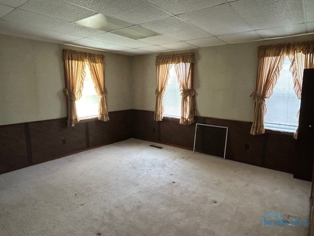 18375 County Road R, Alvordton, OH 43501 - unfurnished room with wainscoting, healthy amount of natural light, a paneled ceiling, carpet floors, and wooden walls