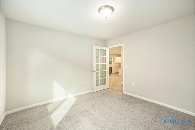 1487 Lee Ann Ave, Defiance, OH 43512 - carpeted empty room featuring baseboards and french doors