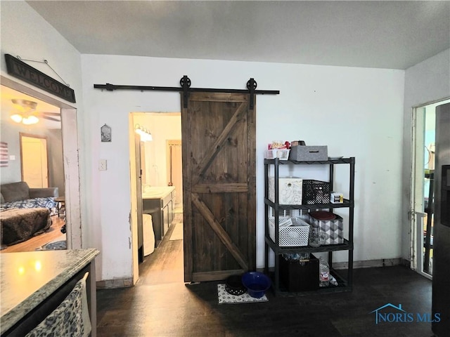 114 E N St, Wayne, OH 43466 - bedroom featuring a barn door and dark wood-style flooring