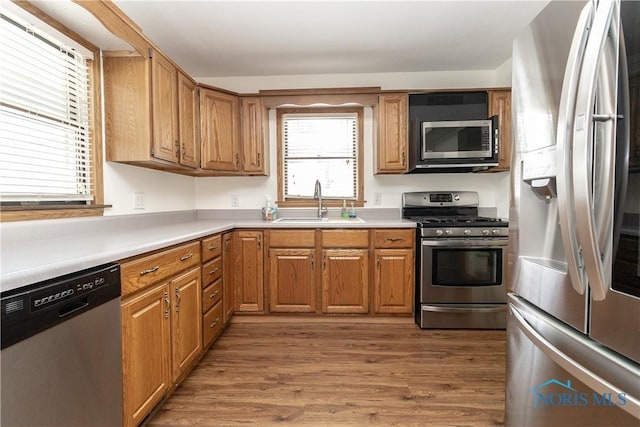 512 State St, Elmore, OH 43416 - kitchen featuring stainless steel appliances, light wood-type flooring, light countertops, and brown cabinetry