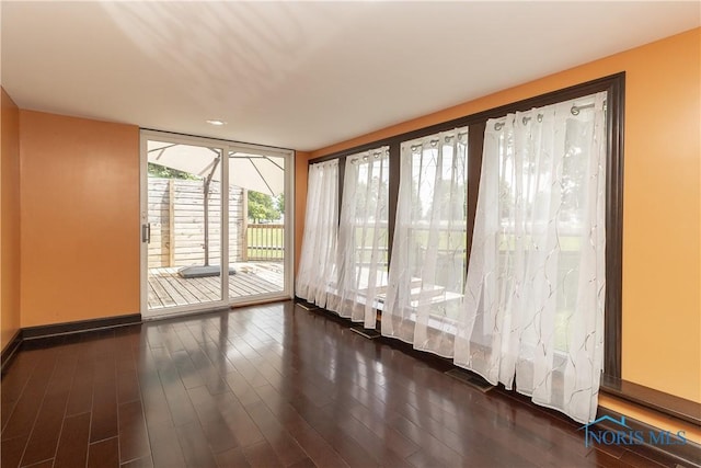 512 State St, Elmore, OH 43416 - spare room with expansive windows and dark wood-style flooring