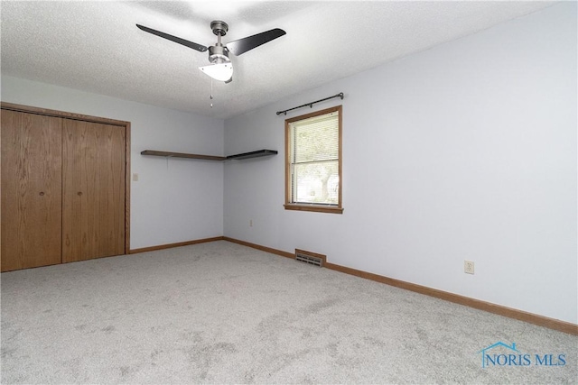 512 State St, Elmore, OH 43416 - unfurnished bedroom featuring carpet floors, a closet, and a ceiling fan