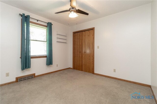 512 State St, Elmore, OH 43416 - empty room with carpet floors and a ceiling fan