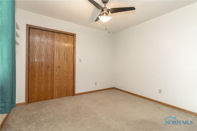 512 State St, Elmore, OH 43416 - unfurnished bedroom featuring light colored carpet, a closet, and a ceiling fan