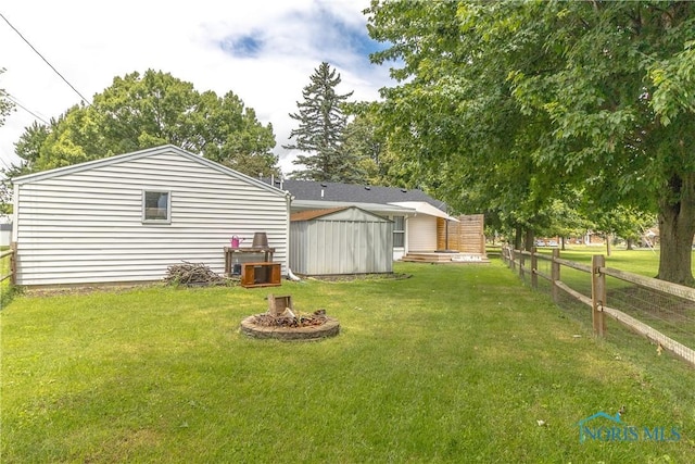 512 State St, Elmore, OH 43416 - view of yard featuring a fire pit and a storage shed