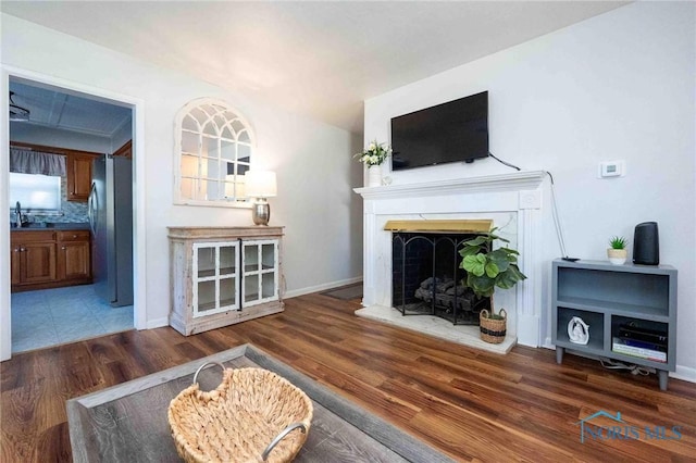 1201 S Blanchard St, Findlay, OH 45840 - living room featuring wood finished floors and a fireplace with raised hearth