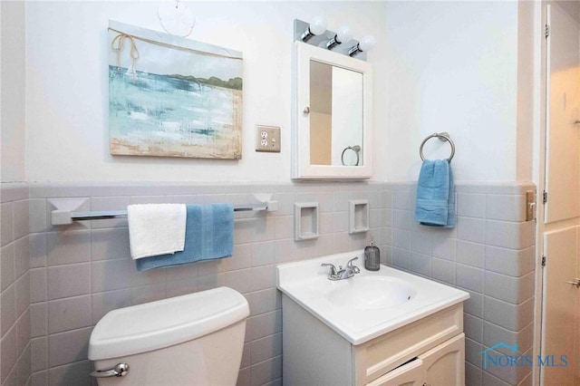 1201 S Blanchard St, Findlay, OH 45840 - bathroom featuring tile walls, wainscoting, and vanity