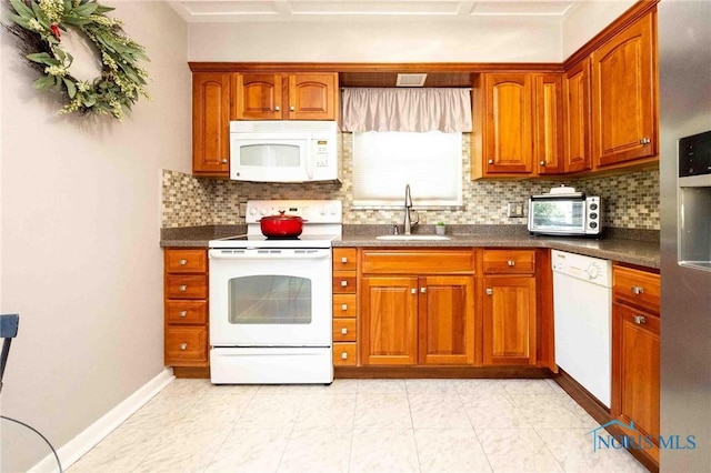 1201 S Blanchard St, Findlay, OH 45840 - kitchen with white appliances, tasteful backsplash, dark countertops, and brown cabinets