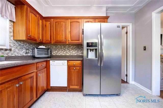 1201 S Blanchard St, Findlay, OH 45840 - kitchen with stainless steel fridge, dishwasher, backsplash, and brown cabinetry