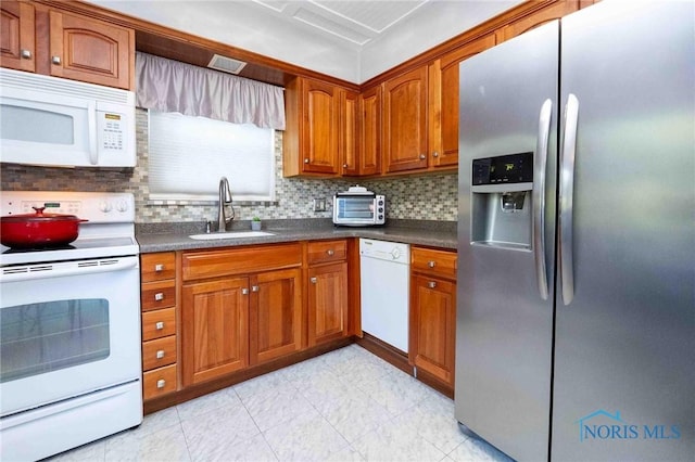 1201 S Blanchard St, Findlay, OH 45840 - kitchen with white appliances, brown cabinets, decorative backsplash, and dark countertops