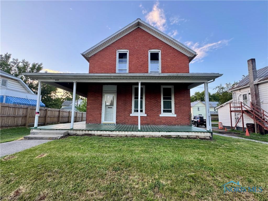 310 Hopkins St, Defiance, OH 43512 - view of front of house with brick siding and a porch