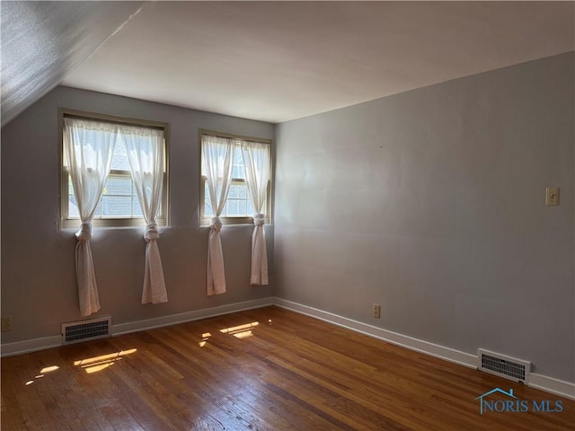 610 E High St, Defiance, OH 43512 - empty room with wood finished floors and vaulted ceiling