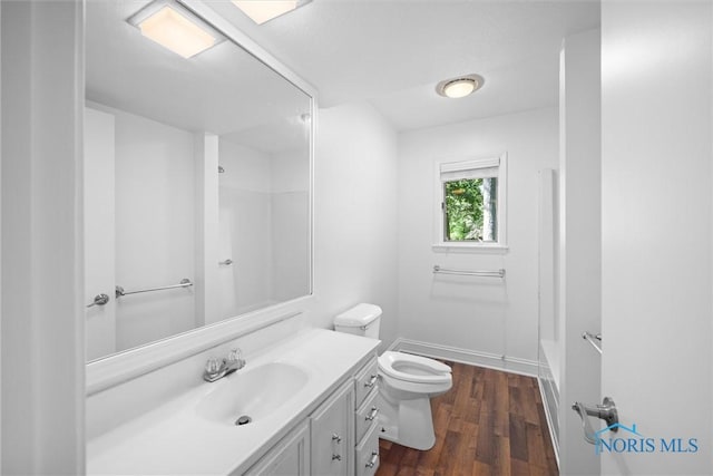639 S Main St, Swanton, OH 43558 - full bathroom with vanity, a shower, wood finished floors, and a tub to relax in