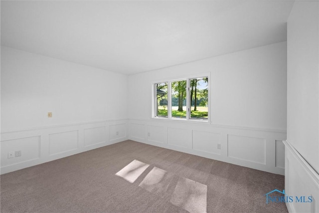 639 S Main St, Swanton, OH 43558 - carpeted spare room with wainscoting and a decorative wall