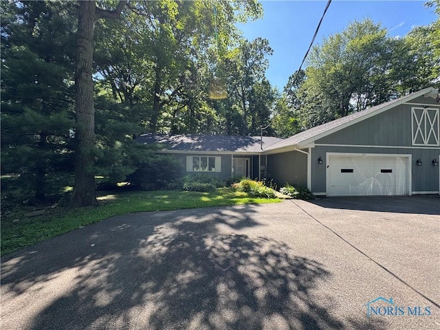 639 S Main St, Swanton, OH 43558 - view of front of property featuring driveway and a garage