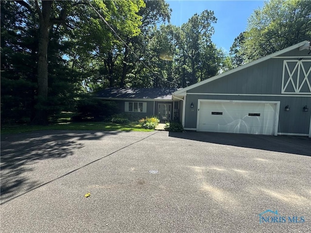 639 S Main St, Swanton, OH 43558 - view of property exterior featuring asphalt driveway and an attached garage