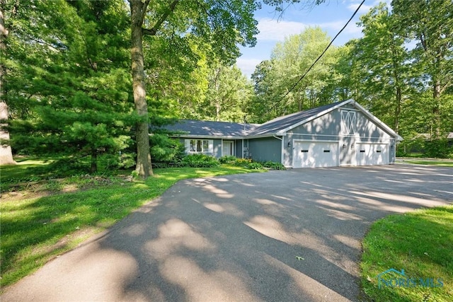 639 S Main St, Swanton, OH 43558 - view of front facade featuring asphalt driveway and an attached garage