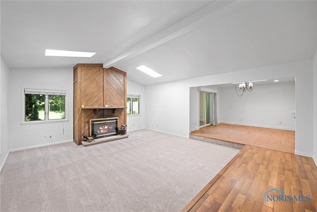 639 S Main St, Swanton, OH 43558 - unfurnished living room featuring a chandelier, a fireplace, and light wood-type flooring