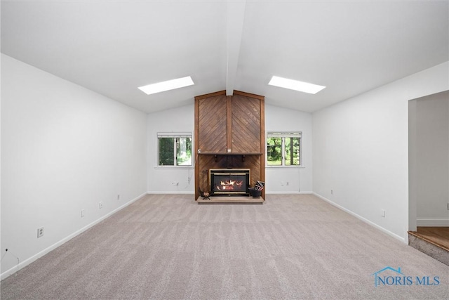 639 S Main St, Swanton, OH 43558 - unfurnished living room featuring a skylight, a fireplace, and light colored carpet