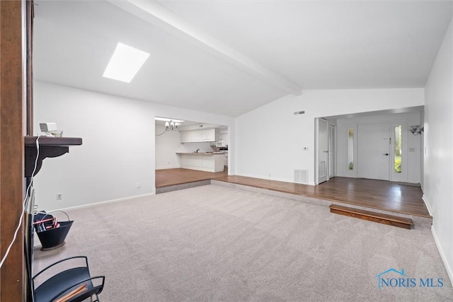 639 S Main St, Swanton, OH 43558 - unfurnished living room with carpet, a chandelier, and a skylight
