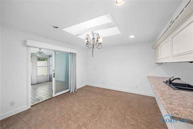 639 S Main St, Swanton, OH 43558 - unfurnished dining area with a chandelier, a skylight, recessed lighting, and ceiling fan