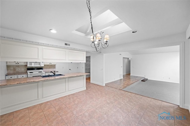 639 S Main St, Swanton, OH 43558 - kitchen with white appliances, a chandelier, white cabinetry, light stone countertops, and hanging light fixtures