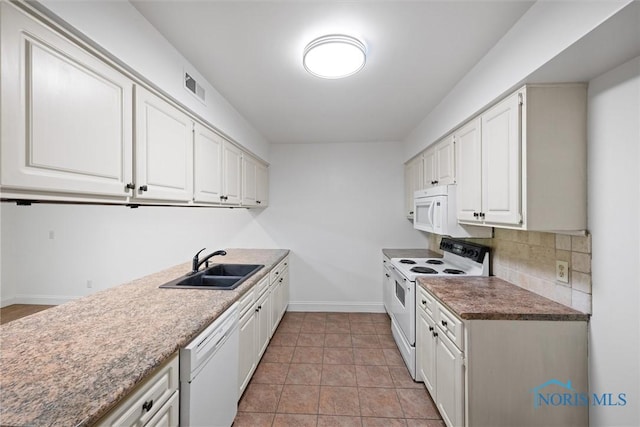 639 S Main St, Swanton, OH 43558 - kitchen with white appliances, backsplash, and white cabinets