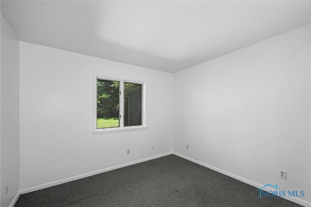 639 S Main St, Swanton, OH 43558 - spare room featuring dark carpet