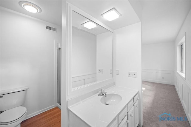 639 S Main St, Swanton, OH 43558 - bathroom featuring vanity, wainscoting, and a decorative wall
