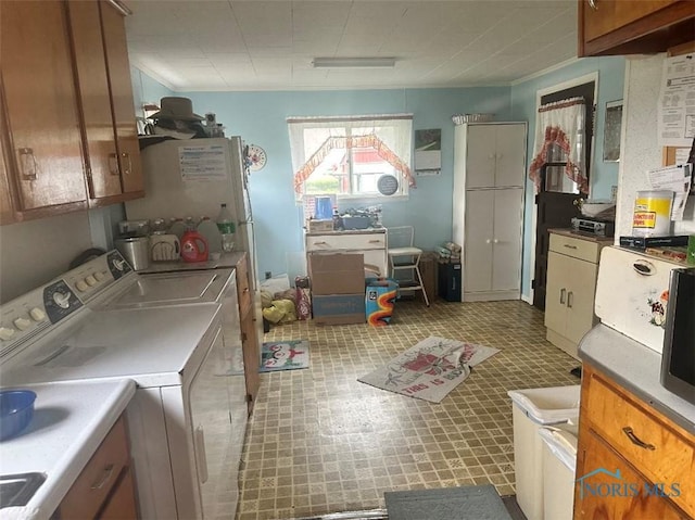 6646 W US Highway 6, Helena, OH 43435 - kitchen with washer and dryer, brown cabinetry, and light countertops