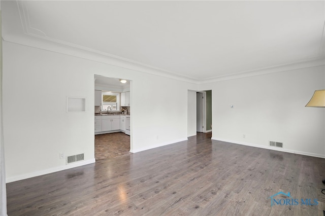 1247 Hugo St, Maumee, OH 43537 - spare room featuring crown molding and dark wood-style floors
