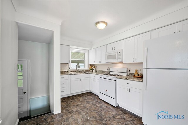 1247 Hugo St, Maumee, OH 43537 - kitchen featuring white appliances, white cabinetry, light stone countertops, and stone finish floors